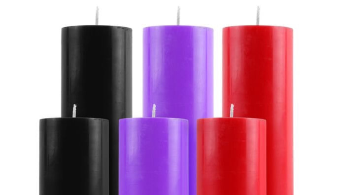 Body candles used for temperature play during a femdom scene.